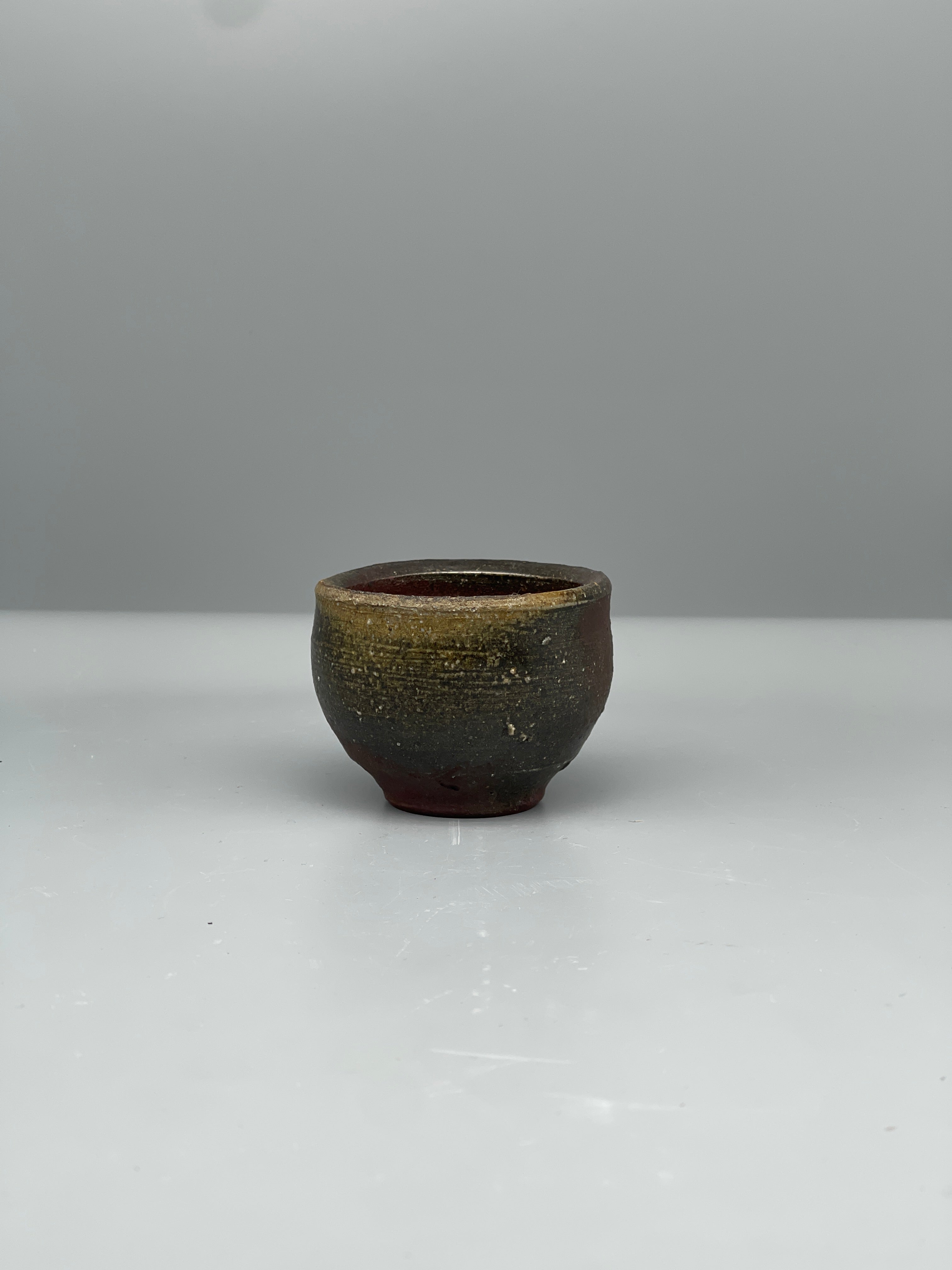 Vintage Japanese bizen guinomi cup, gold-flecked, side view