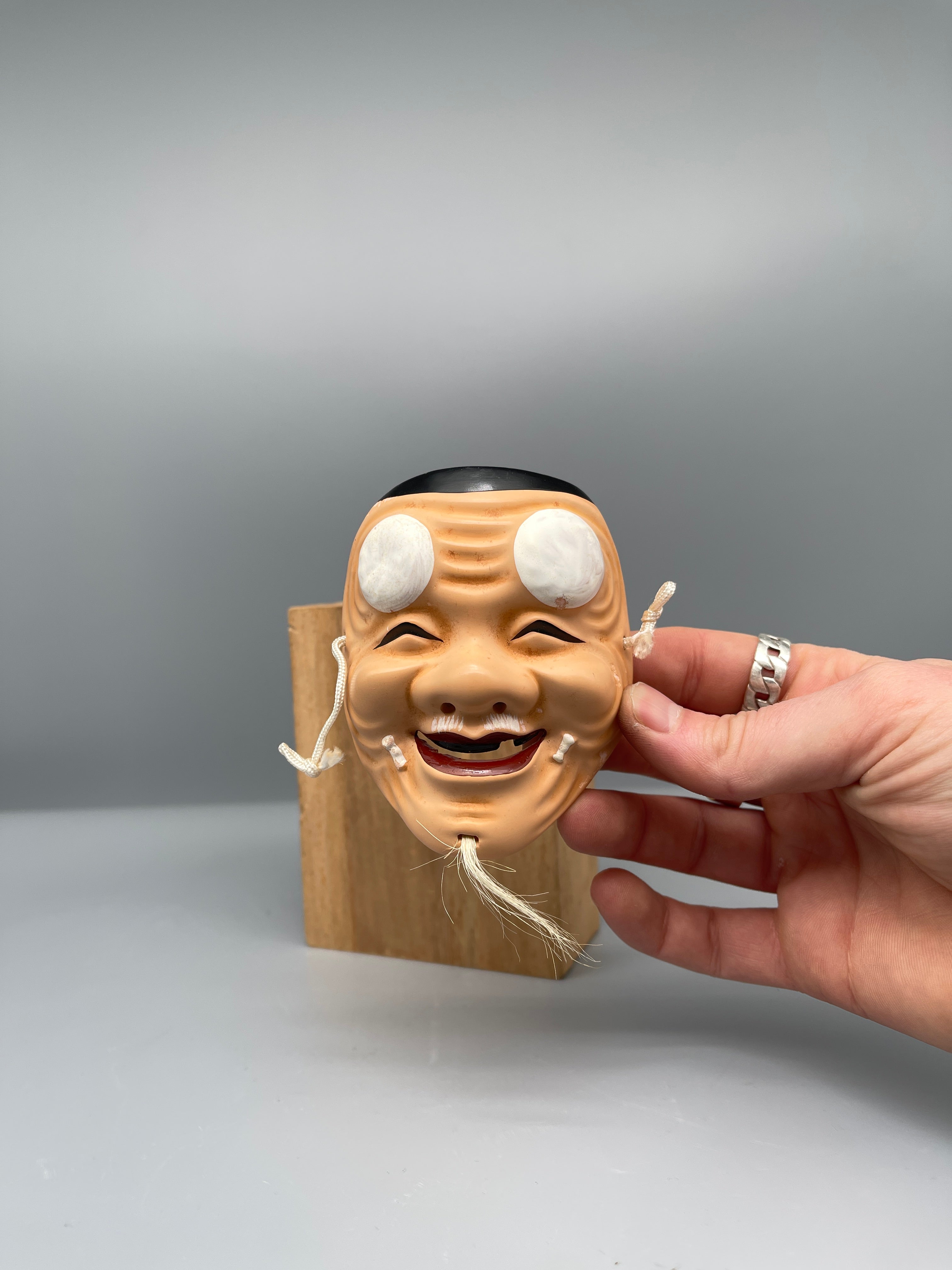 Vintage Japanese carved mask, old man, held view