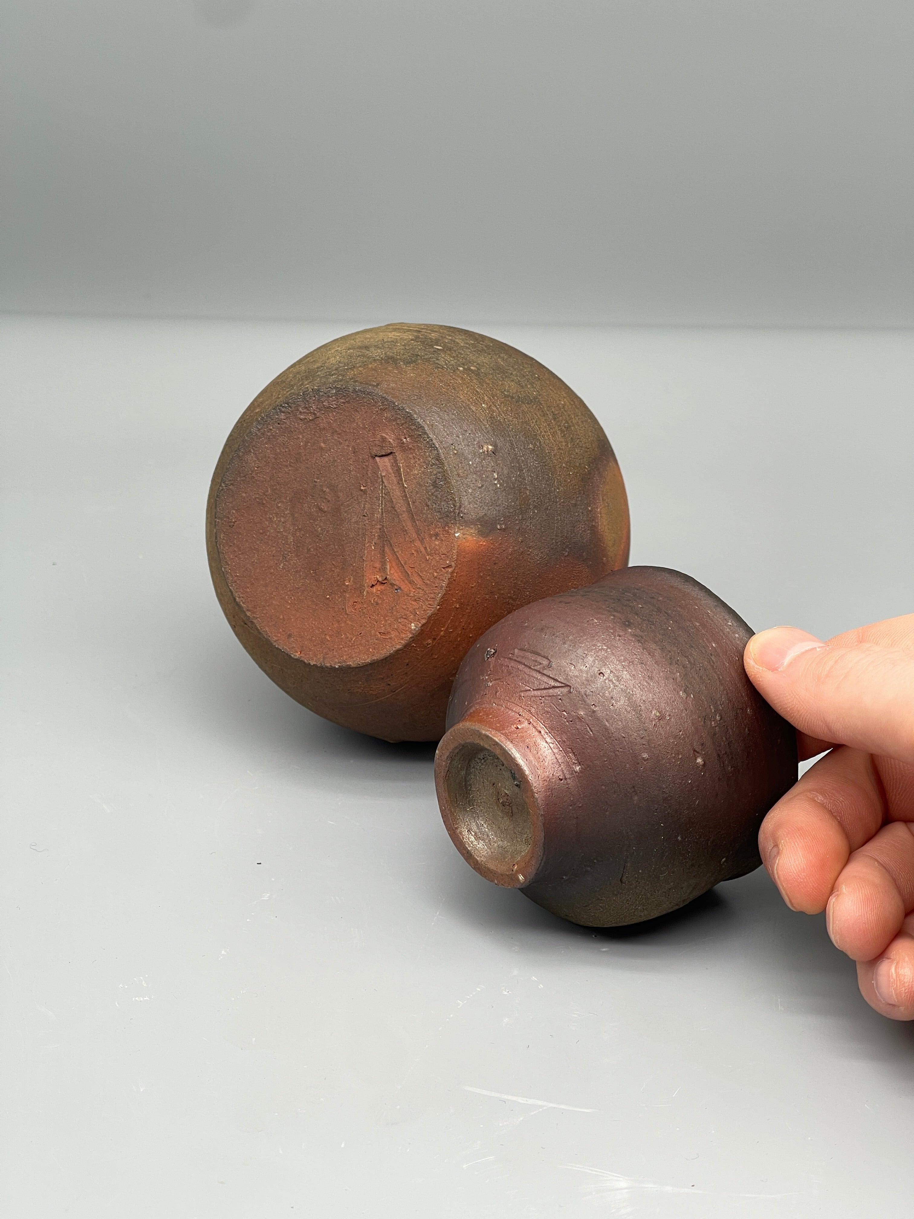 Vintage Japanese bizen sake bottle and cup, close up