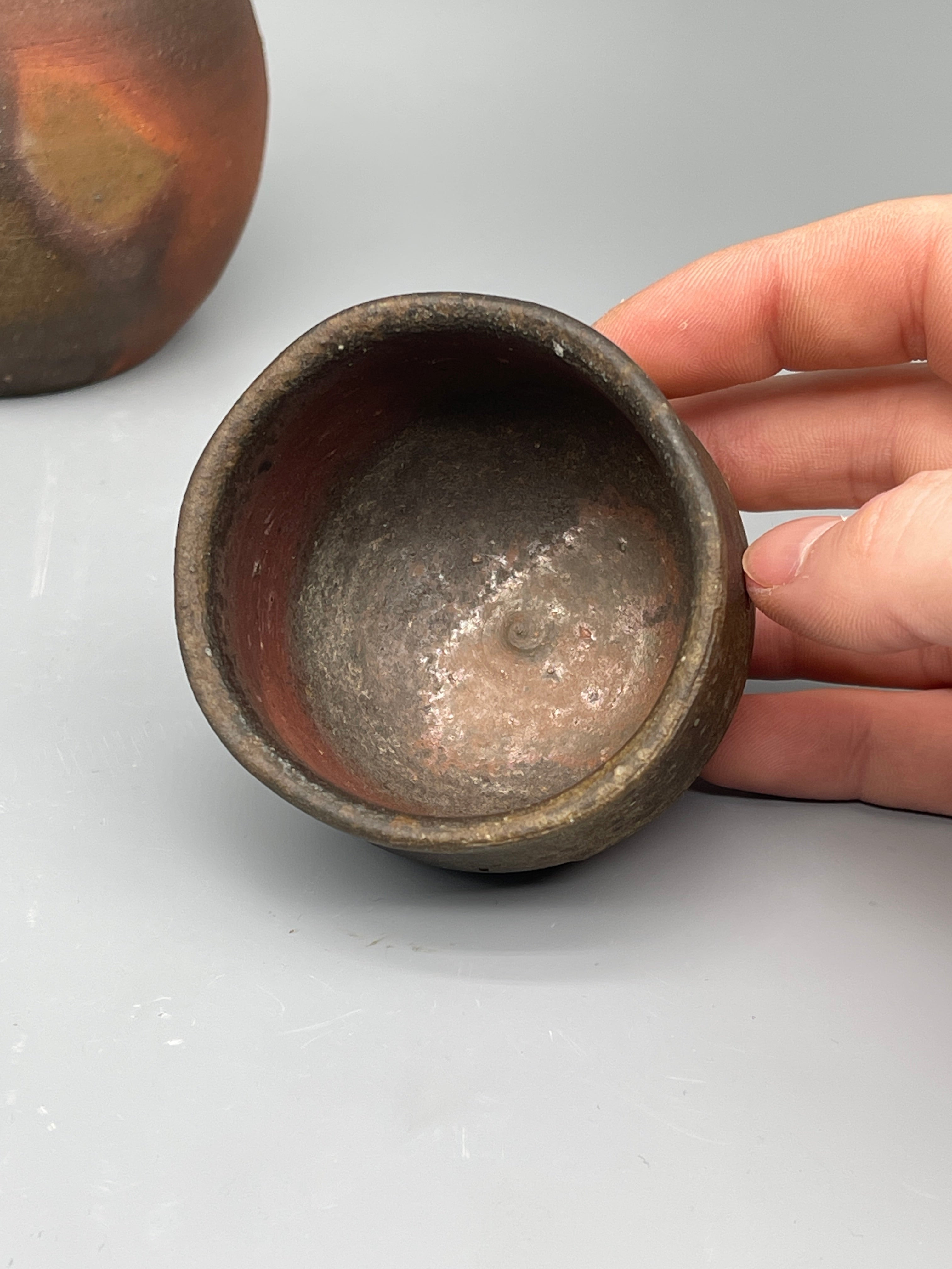 Vintage Japanese bizen cup, held for scale