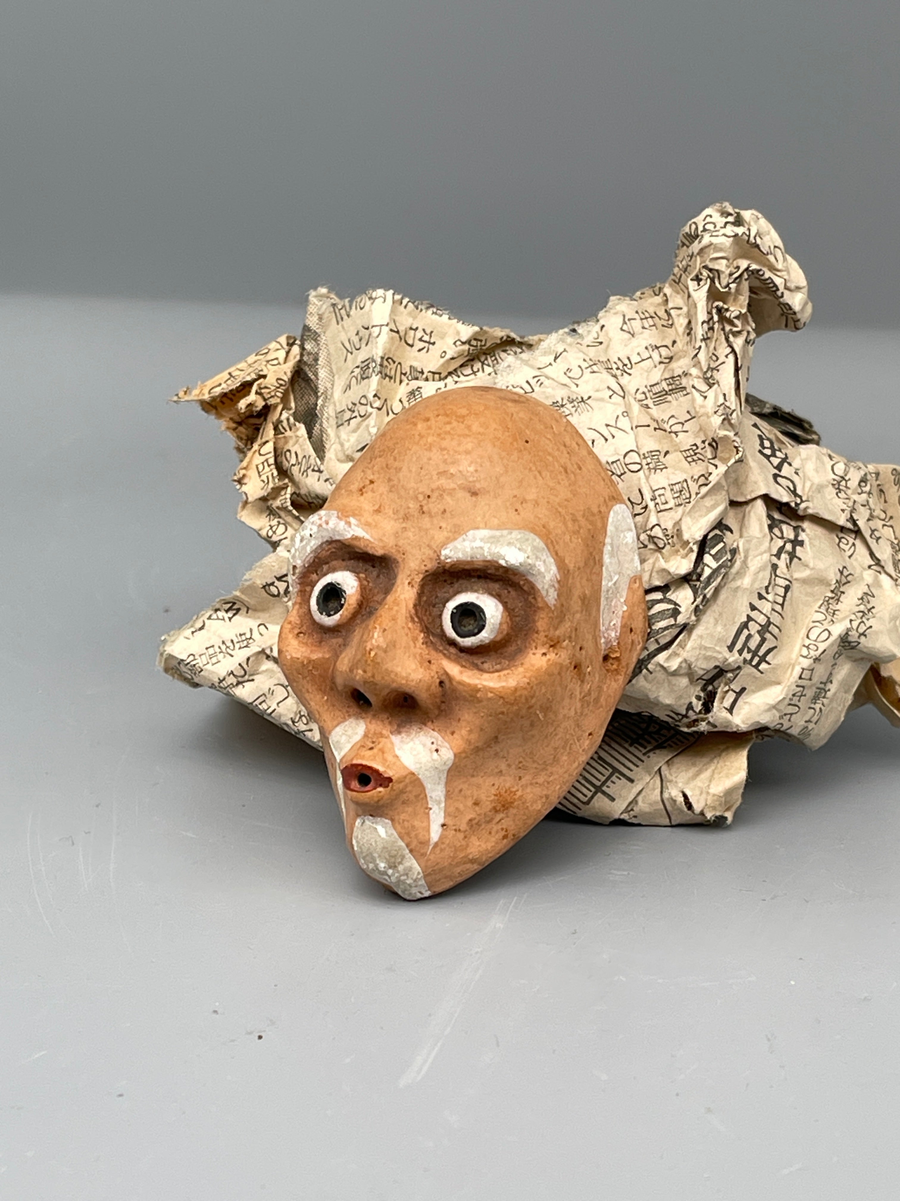 Vintage Japanese usobuki mask, painted beard, held view