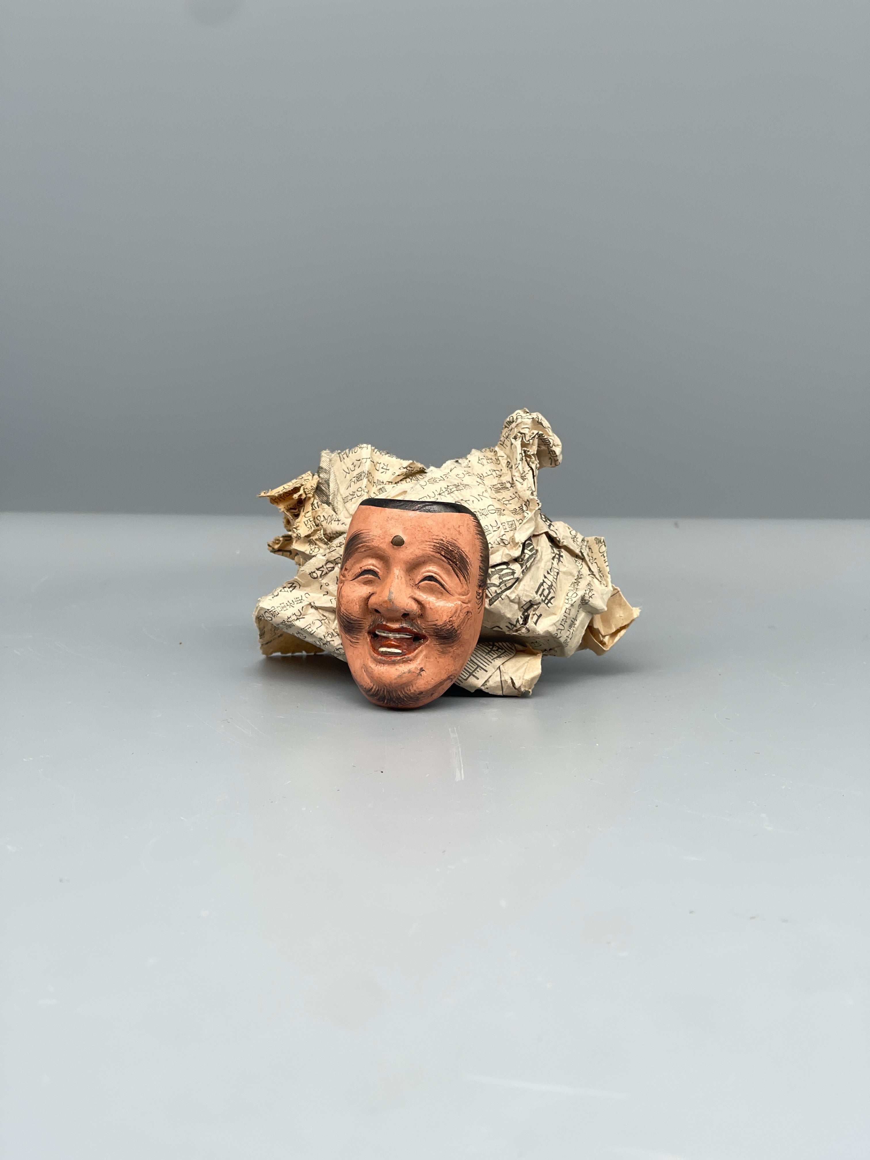 Vintage Japanese carved mask, smiling face, detail