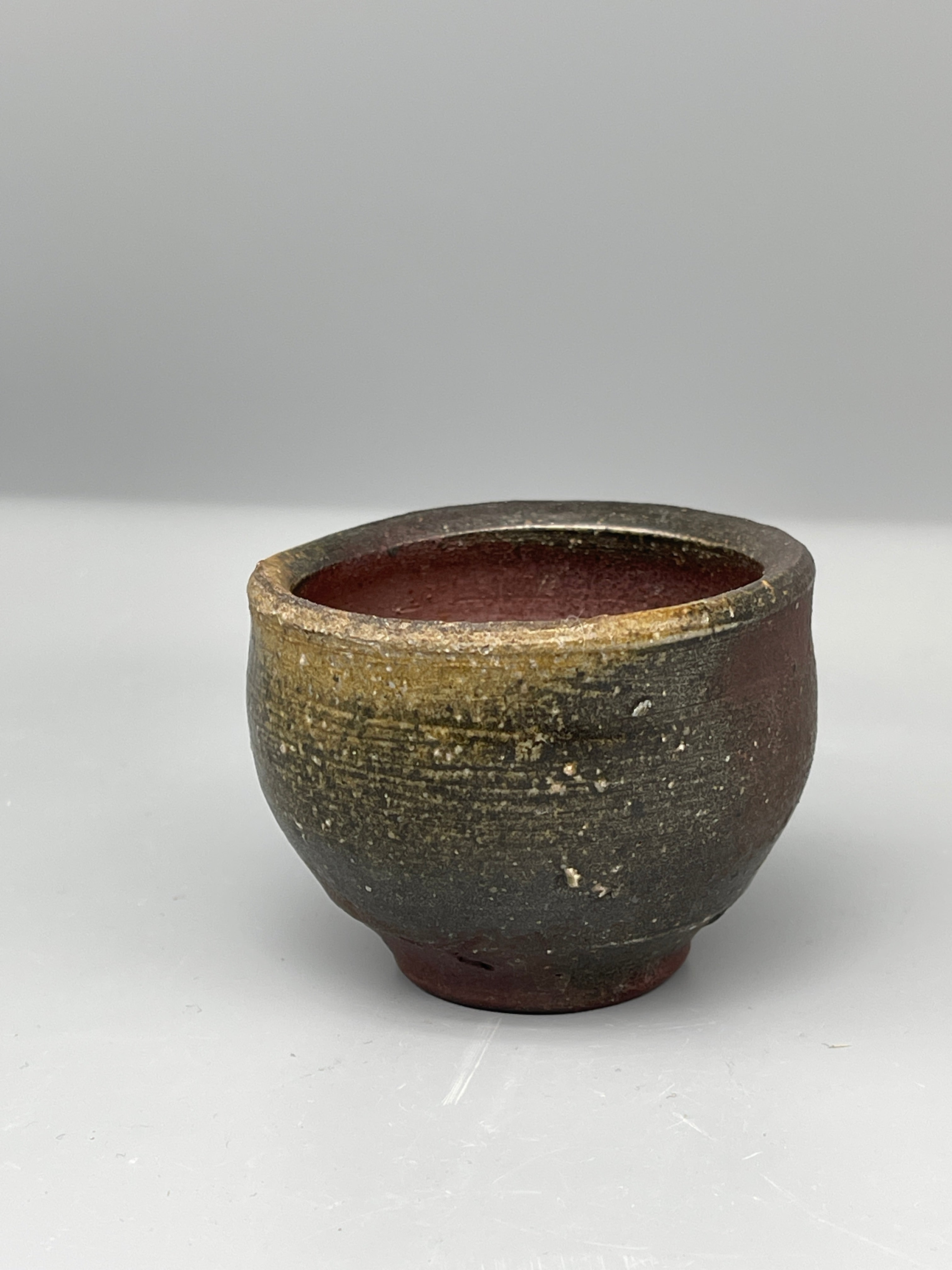 Vintage Japanese bizen guinomi cup, gold-flecked, interior view