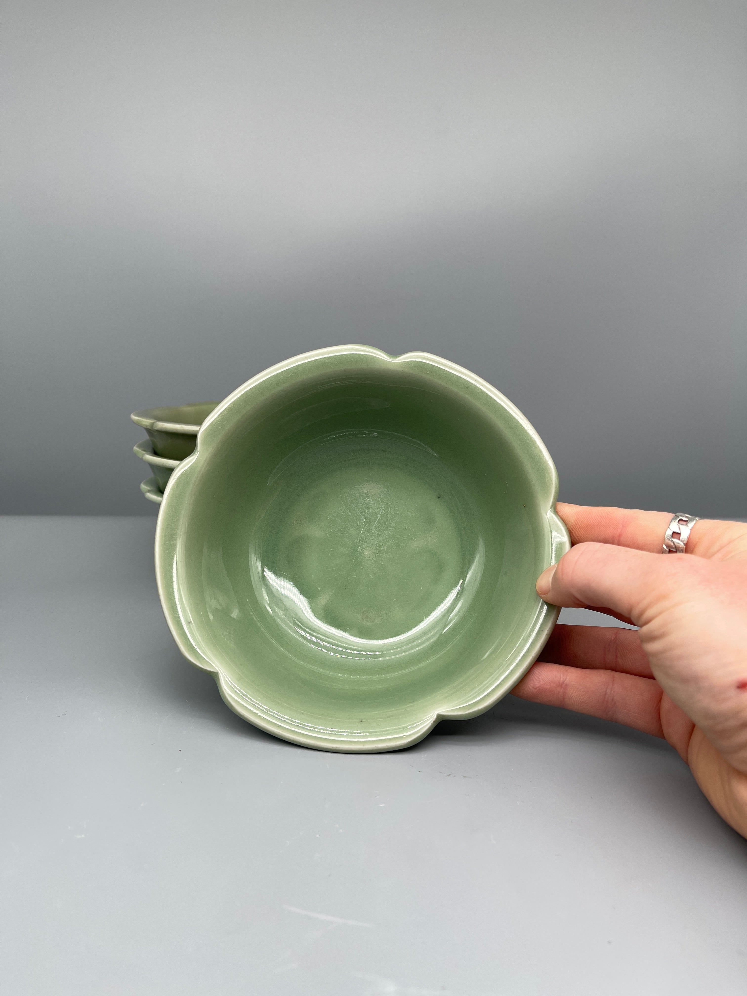 Vintage Japanese celadon lobed dish, held for scale